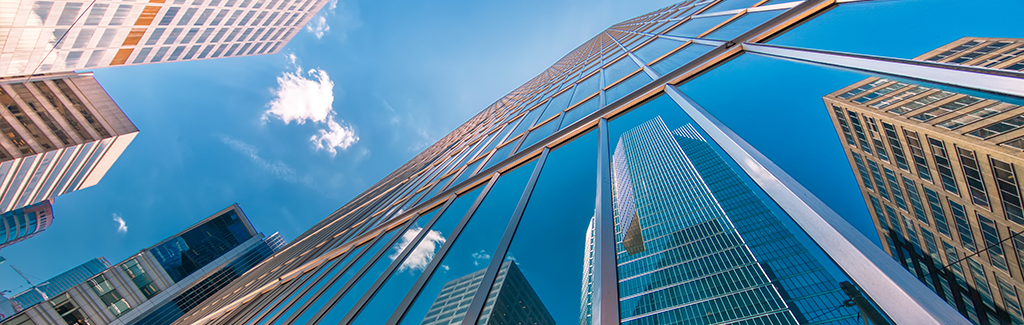 Commercial Insurance - View looking up at glass high-rise buildings